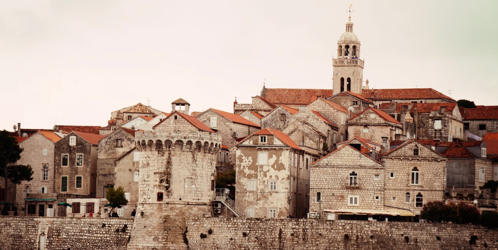 View of old brick and cobblestone architecture with terracotta rooftops in Croatia