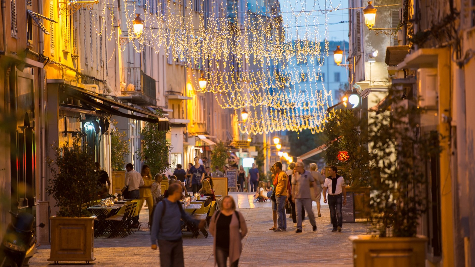 Evening stroll through a charming, lantern-lit street in Corsica, France—part of a cultural Corsica tour experience.