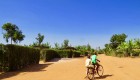 Two local kids riding a bike in a village in Rwanda 